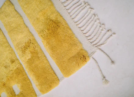 Handwoven Mrirt rug in natural wool, geometric patterns, soft texture.